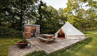 Bell tent with patio seating and enclosed kitchenette