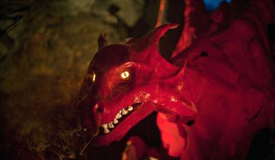 A red dragon with smoke coming from its nostrils