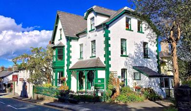 The white and green exterior of Crafnant House, a B&B in Trefriw, Snowdonia, North Wales