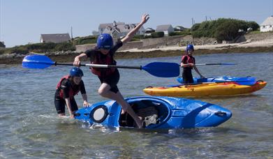young people having fun in kayaks, Rhoscolyn