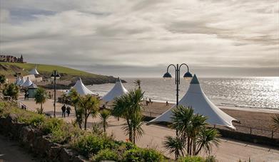 The south-facing beach of Whitmore Bay at Barry Island is a sweeping crescent of perfect golden sand flanked by a wide promenade.  Lots of seaside att