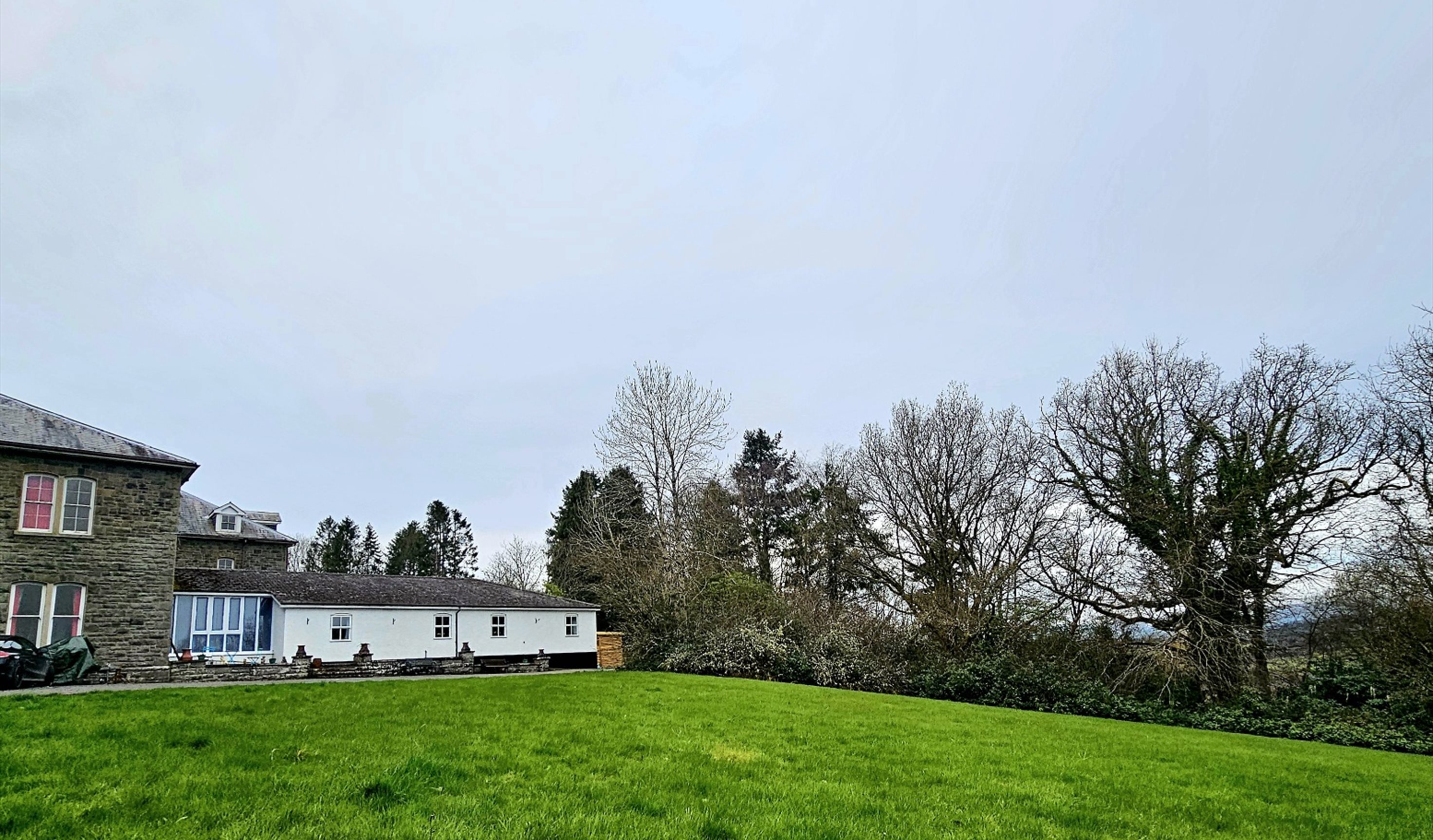 Exterior of property with extensive lawn.