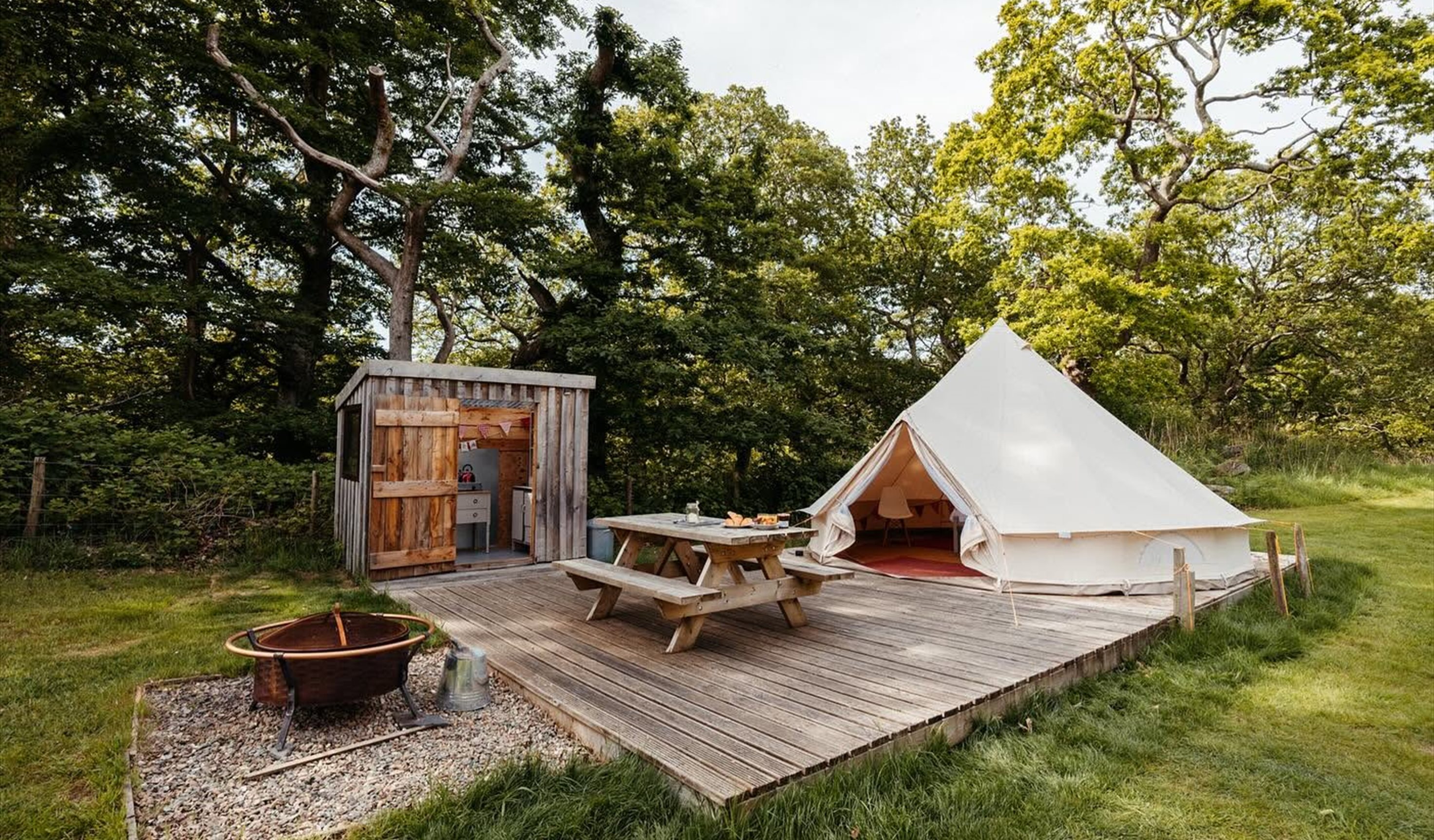 Bell tent with patio seating and enclosed kitchenette