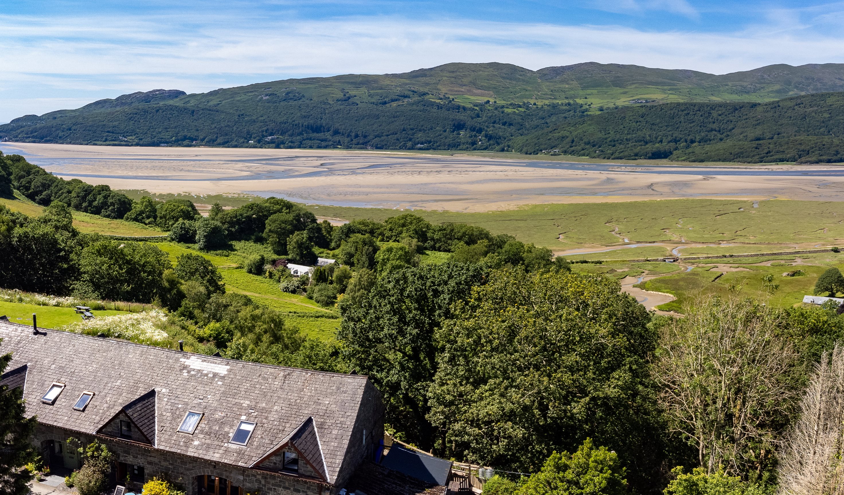 External view of cottages form above, with views of the estuary.