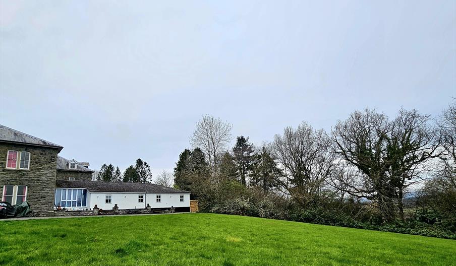 Exterior of property with extensive lawn.