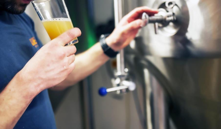 Our Brewer, Tom, sampling a beer before bottling.