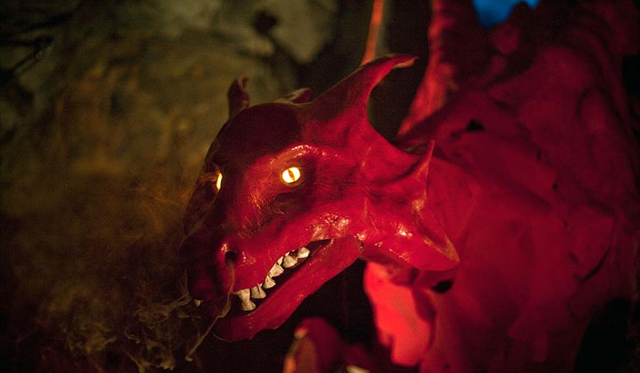 A red dragon with smoke coming from its nostrils