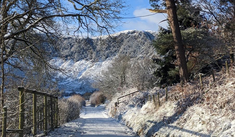 Walking down the lane alongside the farm in winter. Snow and frost over the hills.