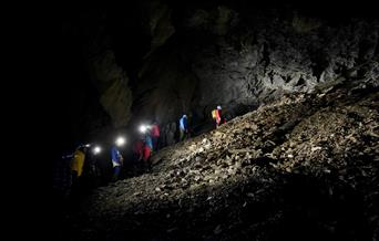 Climbing up a slate heap with Corris Mine Explorers in Mid Wales