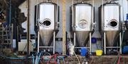 Three fermenters outside of the Brewery.