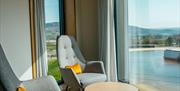 Seating area in from of hotel window overlooking inland surf lagoon