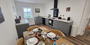 Kitchen with large dining table in Bell cottage.