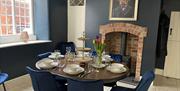 Dining area with log burner and fireplace.