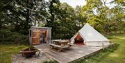 Bell tent with patio seating and enclosed kitchenette