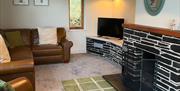 Lounge interior with arm chair, sofa and open fire
