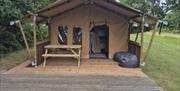 Safari tent, front view, with patio and fire pit