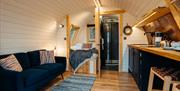 Interior with view of kitchentte, seating and enclosed bedroom