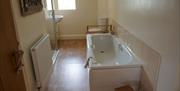 Main bathroom with bath, washbasin, toilet and shower