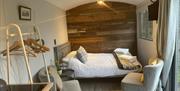 Interior of Glenys with double bed and seating.