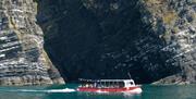 Passenger boat Ermol 6, during a one hour dolphin spotting trip, cruising along the rugged coastline of the Cardigan Bay Special Area of Conservation,