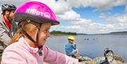 Family pausing to enjoy view over lake Llyn Brenig Cycling Conwy