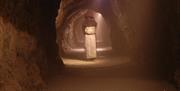 A Dark Age Boatman will sail you underground and then guide you, on foot,  through the underground tunnels and vast caverns of the Labyrinth to find a