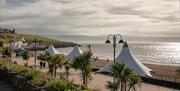 The south-facing beach of Whitmore Bay at Barry Island is a sweeping crescent of perfect golden sand flanked by a wide promenade.  Lots of seaside att