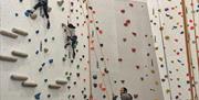 Mum and dad hold the ropes for their two little girls in a quiet area of easy climbs.