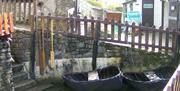 examples of ancient fishing craft on display on the water courses supplying the Water Wheel at the Mill