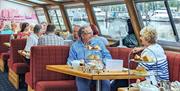 People aboard the cruise, having afternoon tea