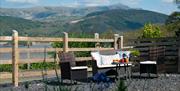 Patio with outdoor dining and view of the mountains behind.