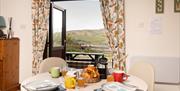 Breakfast table with patio doors and access to outside