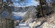 Walking down the lane alongside the farm in winter. Snow and frost over the hills.