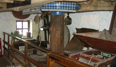 Inside the 12th century water powered Mill showing the grinding stones used to crush up the grain into flour