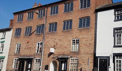 The building was originally six two-room cottages with 2 loom floors above. Each window had a loom. Now the cottages relate the woollen industry story