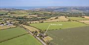 Bwthyn y Ddol sits in unspoilt countryside a short distance from the sea. This drones eye view shows this clearly